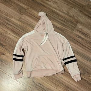 Pink cropped-ish hoodie with black and white stripes. Size medium.